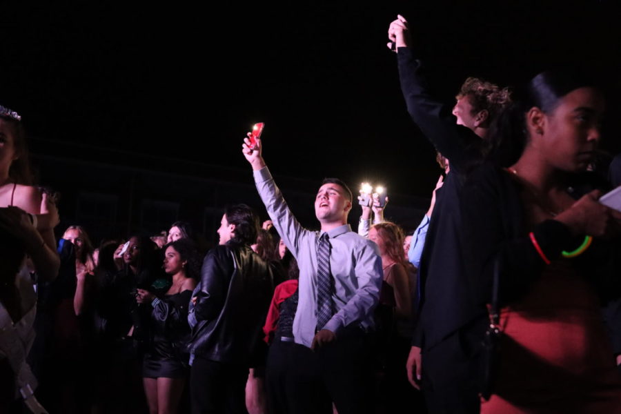 Junior Thaddeus Elam celebrated the crowning of the homecoming king and queen by swaying to the beat with his phones’ flashlights on.  
“They were playing a very romanticized song for the king and queen’s dance, and we were just making light of it,” Elam said. 
Throughout the night, dancing together was a popular way to stay warm, as temperatures in the 50s kept many dancers in jackets.
“It was cold so I beat the cold by wearing a jacket and dancing with my partner,” Elam said. photo by Alexis Izaguirre