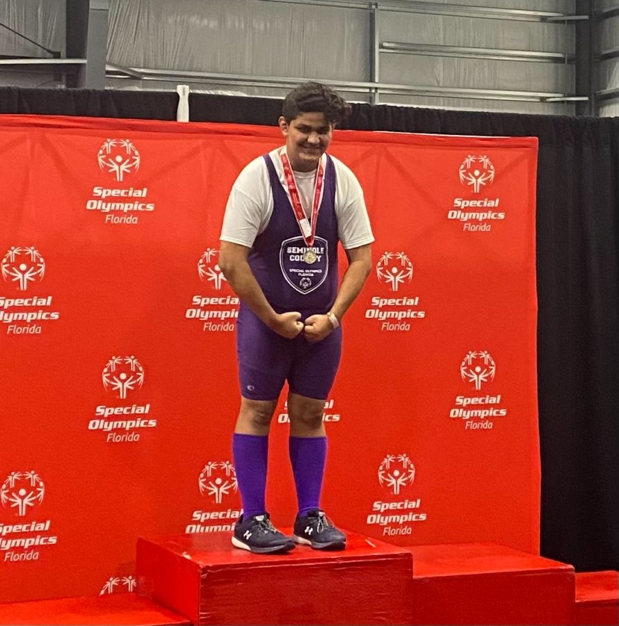 Senior Devon Hawkins on the podium after placing first in the state weightlifting competition. 