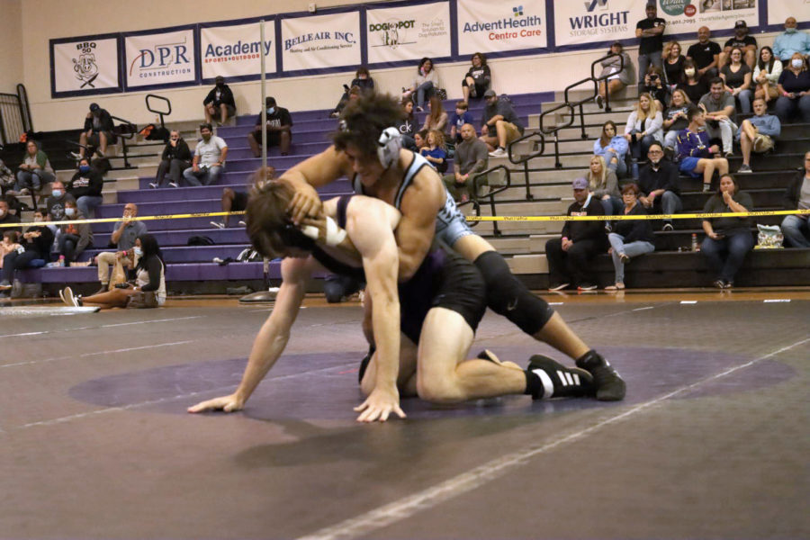 Senior Ethan Gomez is running a power half on top. He is trying to pin his opponent. 