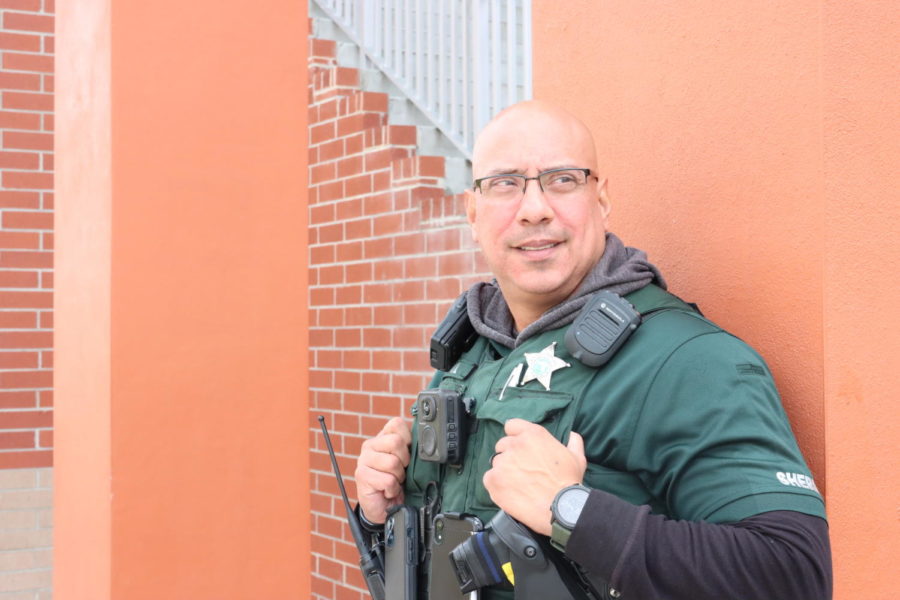 Resource Officer Milton Gil watches over students during break. Gil can be often seen around the courtyard talking to students, staff and other security members.