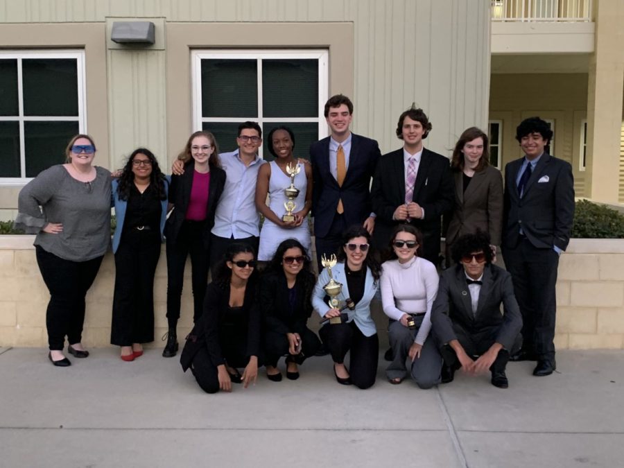 The debate team stands outside of Windemere high school after rounds were finished. Cobb and Tulloch hold their plaques for ranking first and fifth in their events.