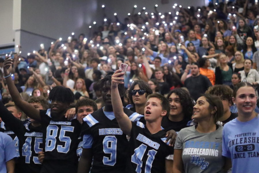 Students sing the Alma Mater at the close of the Aug. 26 pep rally. White light sticks were passed out to students as well.