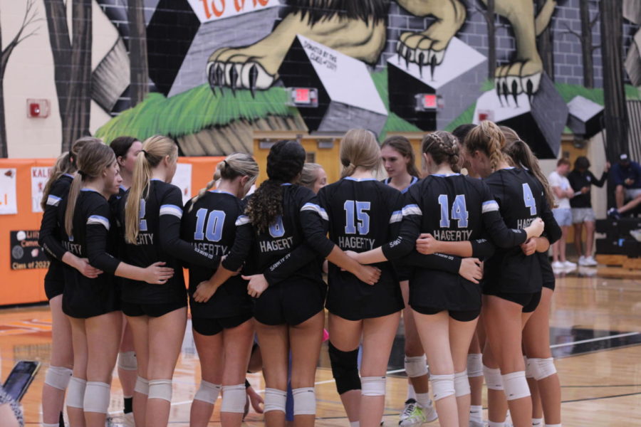 The volleyball team huddles around during a timeout. The girls lost 3-2 in a close game against Oviedo. 