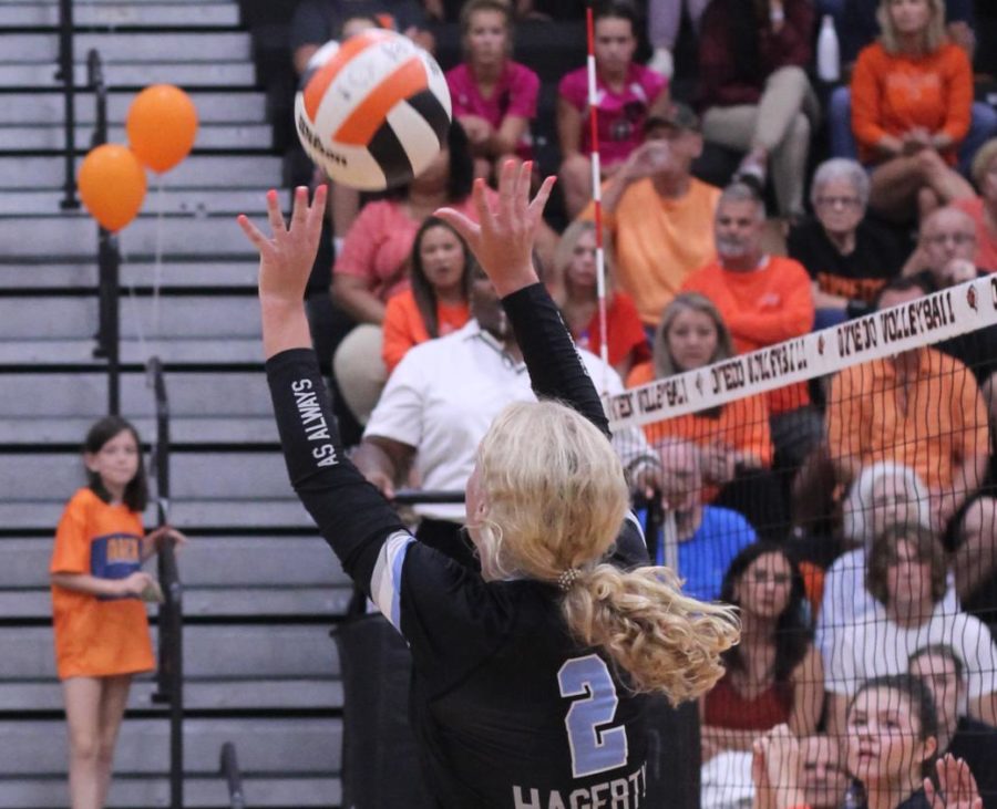 Setter Brielle Mullen sets the ball for outside hitter Abby Mas to spike.  Mullen has been a starting setter for the past two seasons.