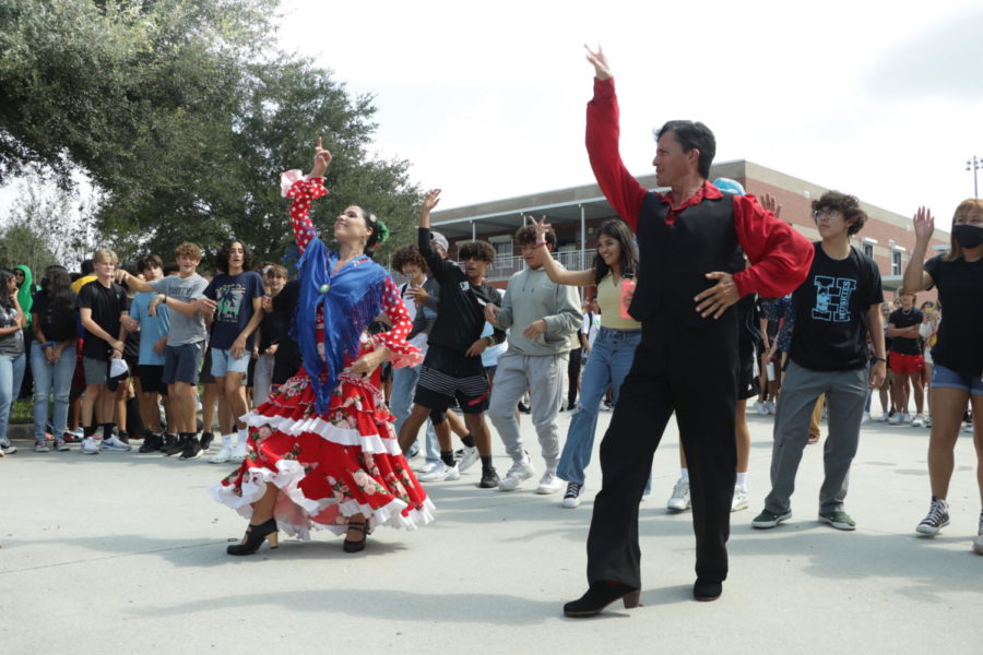 Flamenco dancers Ely Cardenal and Ernesto Caballero lead a dance with the students. During the performance, Cardenal and Caballero invited the students to dance with them, teaching them basic steps.