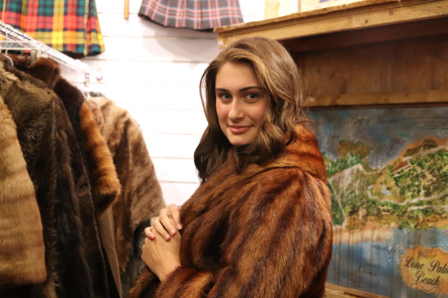 Senior Abby Adkins shops for her favorite 1920s trend, faux fur coats, in a vintage shop. Adkins has been searching for the perfect faux fur coat to add to her vintage collection. 