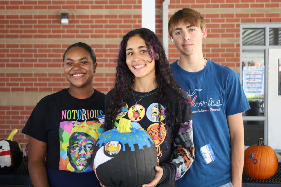 Junior Jordan Wood, ___, ____ holding their second place winning pumpkin, which was inspired by Batman. ____, Wood said.