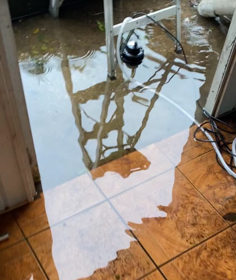 Freshman Alyse Mays porch floods on Thursday during the storm. Alyse  May had to bail water out of her house with her mother to fend off the rising water.
