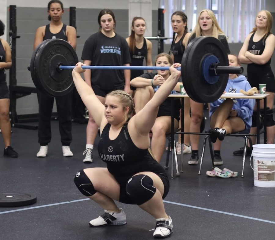 Senior+Ava+Thornsbury+holds+the+bar+above+her+head+while+completing+a+snatch+of+115.+The+snatch+movement+was+introduced+last+year+to+the+competition+and+requires+lifters+to+lift+the+bar+from+the+ground+to+above+their+head+in+one+movement.
