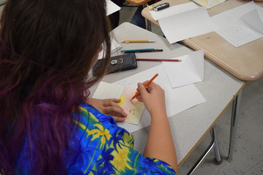 Junior Ashlyn Gorczany draws a sunset inspired picture to pair along with her handwritten poem. The Poet Society created cards to send to sick children through Cards for Warriors. 

