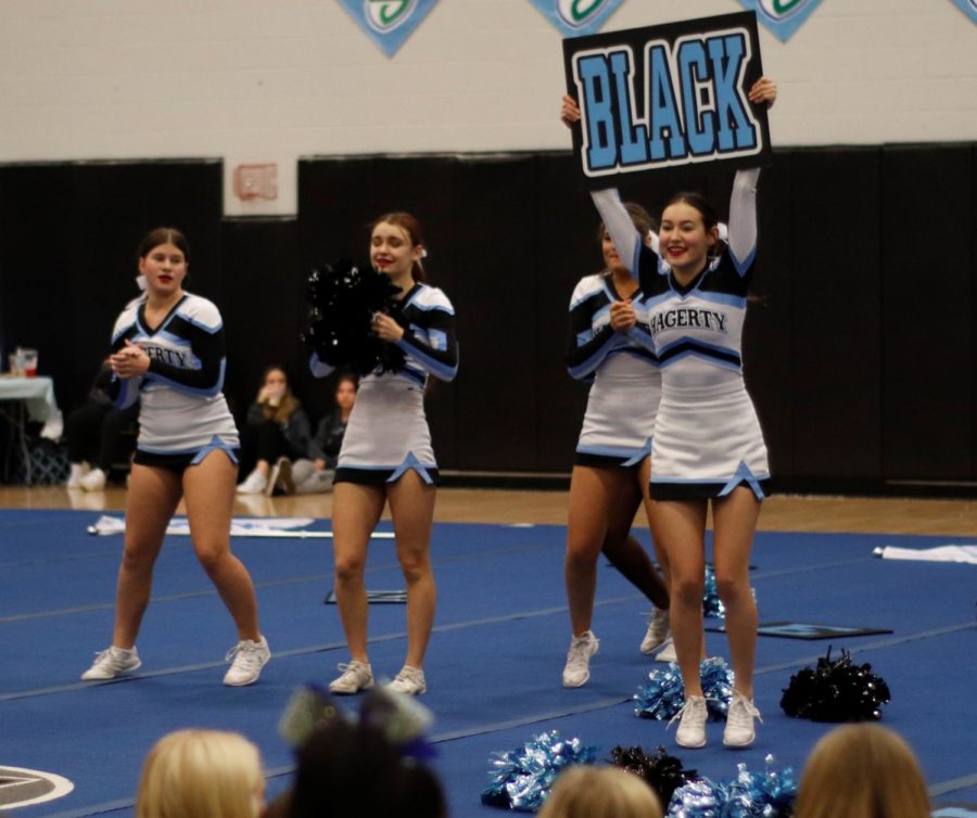 Freshman Skylar Droste, senior Hailey Landon and freshman Jordyn Storti cheer at the Husky Cheer Challenge. They are a part of the junior varsity team that placed third. 