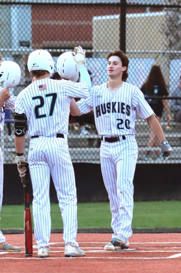 Senior Luis Rivero (left) high fives junior Brayden Toro after hitting a home run in the first inning of the game. Doing well in the start... for the team, let us know that what we worked on in practice was paying off and reinforced our system, Rivero said.