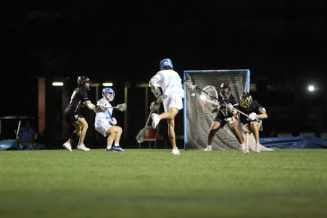 Conner McLaughlin scores a goal during the second half against Bishop Moore. The boys varsity lacrosse scored six unanswered goals in the second half but lost 9-8.
