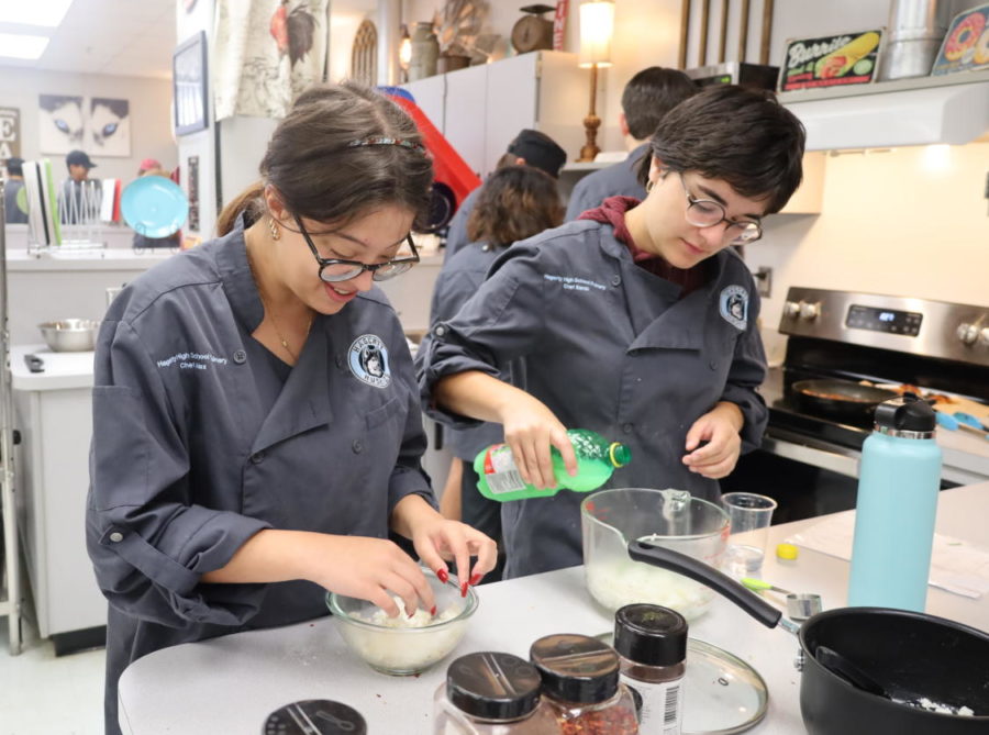 Seniors Alex Popovchi and Sarah Hinnant prepare a meal in Matthew Thompsons second period Culinary IV class. Any student can learn advanced cooking techniques in the summer camp offered by the culinary program this summer.