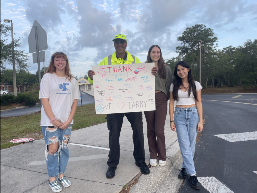 Girl Up officers present Larry Miller with a thank you poster for his donation to their menstrual drive. Miller donated $200 to the group to buy supplies for the school.