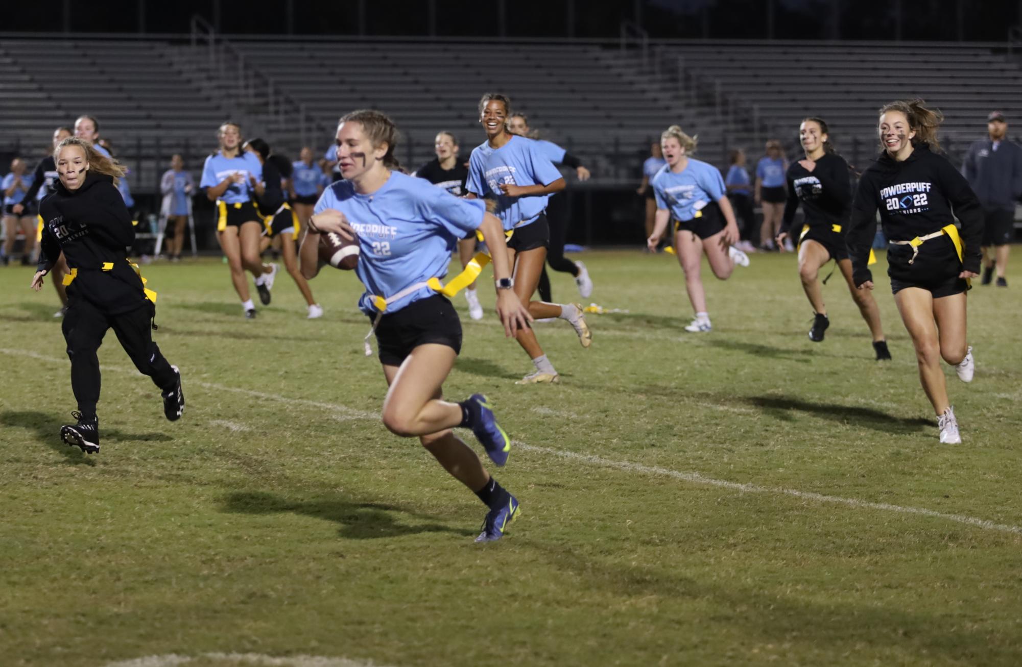 Senior Reagan Varvarigos rushing down the field ahead of the defense, as part of the 2022 powderpuff game. Varvarigos is a varsity soccer player, and will play her third season this year. I think that having a flag football team is a really good opportunity for girls who are interested in football, but wouldnt feel comfortable with typical tackle football.