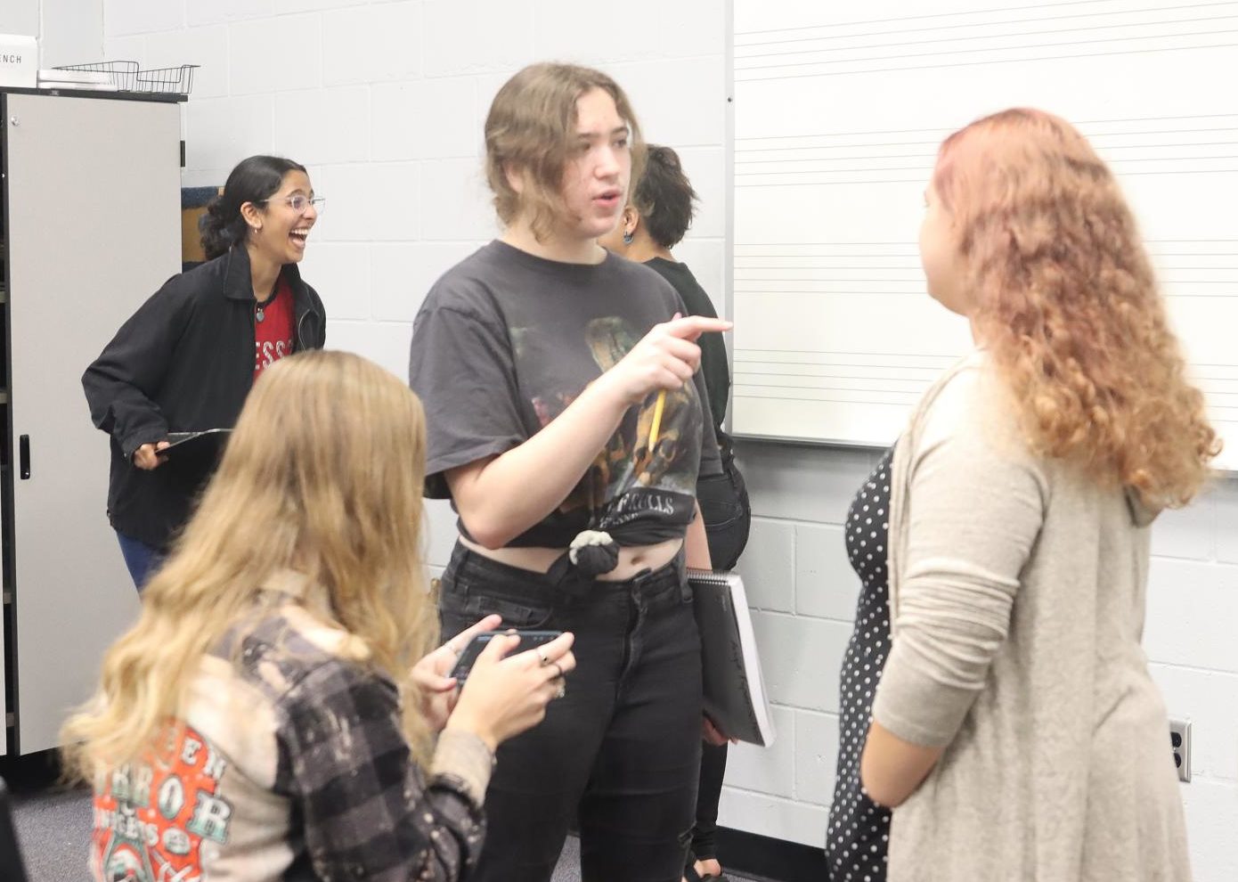 Senior Angela Espenscheid gives her friend some tips before her audition. Chorus teacher Christopher Hickey chose performers based on student ability and song relevance. 