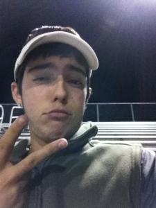 Junior Joey Shulz sends a snapchat during a varsity soccer game.