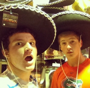 Junior Cory Shulte poses with a friend to capture their matching sombreros for Instagram.