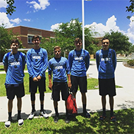 Jacob Faulk, MIchael Gibson, Jordan Engel, James Chapman and Lincoln Mitchell stand outside Oviedo High School at a camp. This was one of 4 camps the team attended this summer.