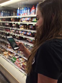 Freshman Aly Schwartz plays Pokémon Go as she shops in Publix with her mother. Schwartz had been playing the game ever since it was recommended to her over social media.