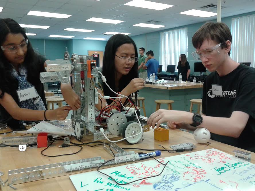 Aashni Patel (left) builds her robot for the camp’s competition. The robot was built to be tested against the other teams.