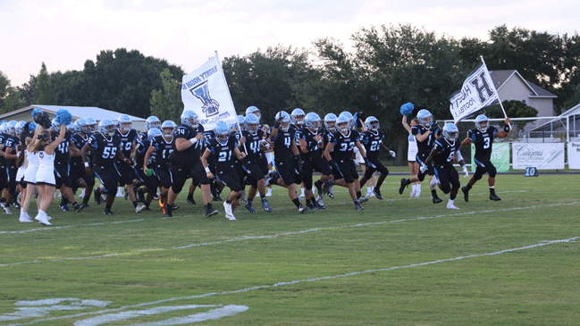 Varsity football runs onto the field at the pre-season game against Freedom. This was the first game of the year, and the first pep rally of the year is Friday, Sept. 9.