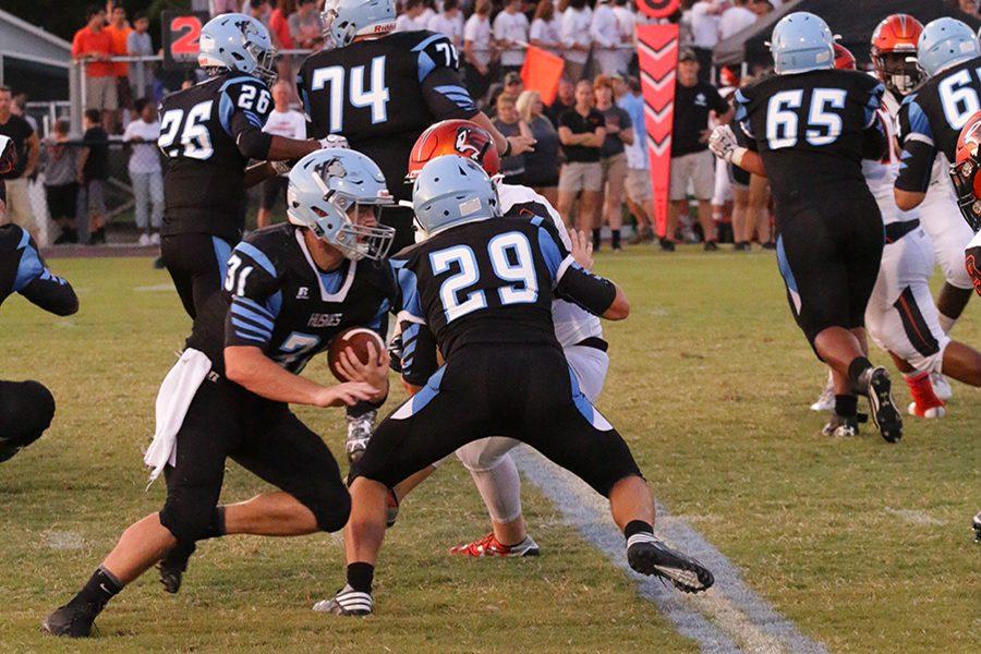 Quarterback Ethan Brewer runs the ball in the first half. The team beat Oviedo 17-10 Friday night, its first win over Oviedo since 2010.