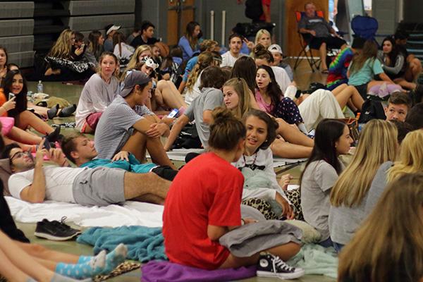 Students settle in in the old gym for the movie.  Flick on the 50 had to be moved indoors due to rain.