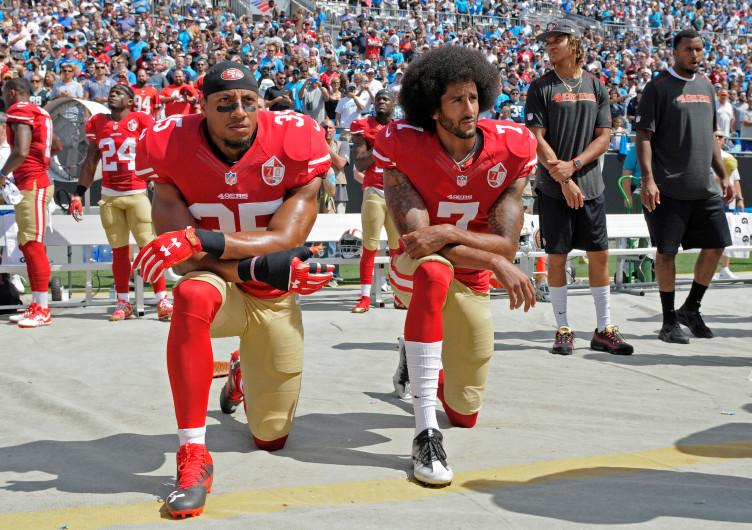 San Francisco 49ers Colin Kaepernick (7) and Eric Reid (35) kneel during the national anthem before an NFL football game against the Carolina Panthers in Charlotte, on Sunday, Sept. 18.(AP Photo/Mike McCarn)