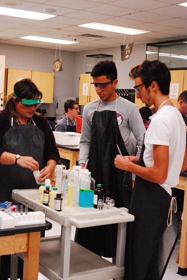 Romina Jannotti(left) helped Daniel Sanchez(middle) and Devin Bracci(right) with handling chemicals for their activity series lab.