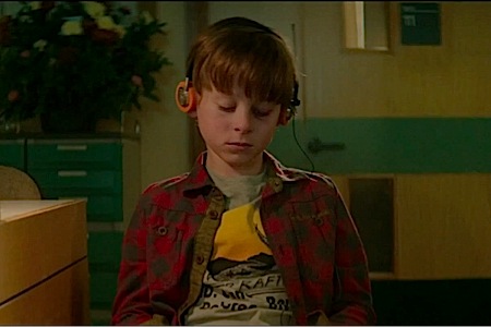 A young Peter Quill (Wyatt Oleff) listens to his Walkman during the beginning of Guardians of the Galaxy.