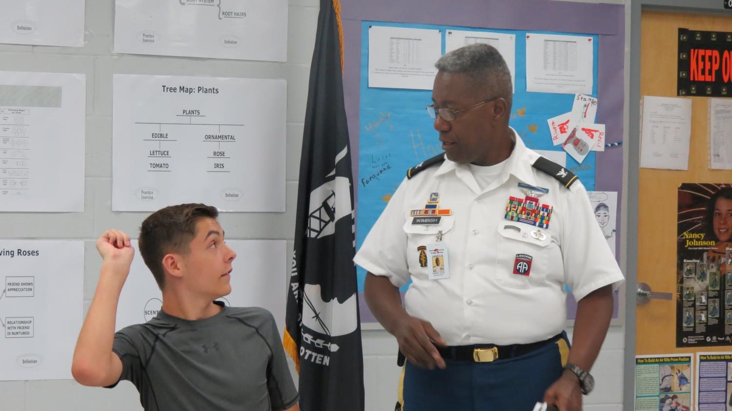 Col. Wimbish answers sophomore Ian Daubers question about the curriculum. Asking questions in JROTC is highly encouraged,    