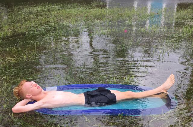Junior Jack Chitty relaxes in the flood at his dads house caused by Hurricane Irma. The flooding did not reach the house or cause any damage. 