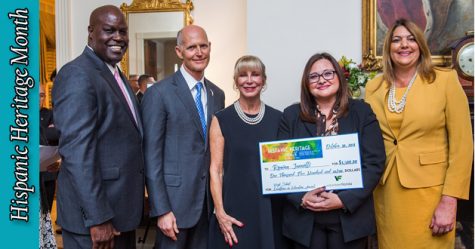 Science teacher Romina Jannotti poses with Gov. Rick Scott and First Lady Anne Scott. Jannotti won the Excellence in Education Award for high school teachers across Florida.