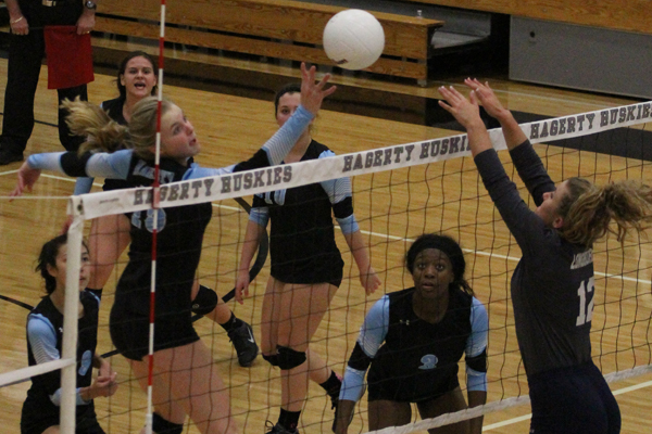 Hitter Sydney Conley spikes the ball against Harmony in the district championship. The team would go on to win 3-0.