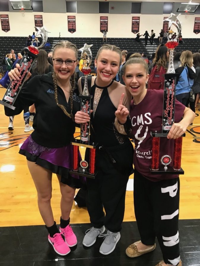 Senior Abby Smith poses with her sisters at a dance competition. Their trio won first place.