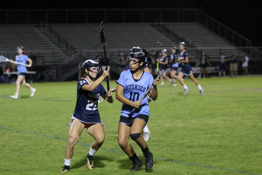 Junior Ashley Rassel works to get around against a Lake Howell player. The game took place on Feb. 27 at the Sam Momary Stadium and resulted in a 19-1 win.