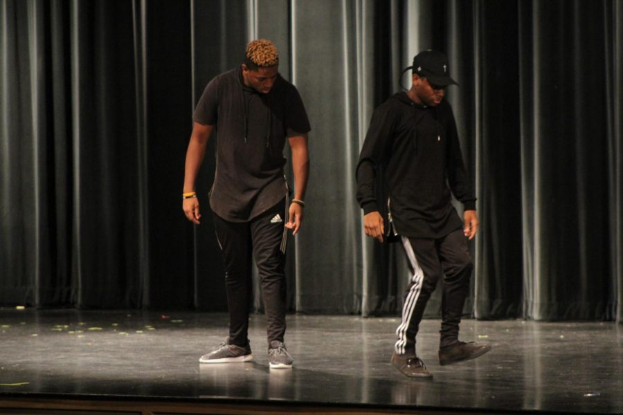 Senior Nasir Roberts and junior Josiah Wright perform one of their dance moves at the talent show. These moves were similar to that of a robot. 