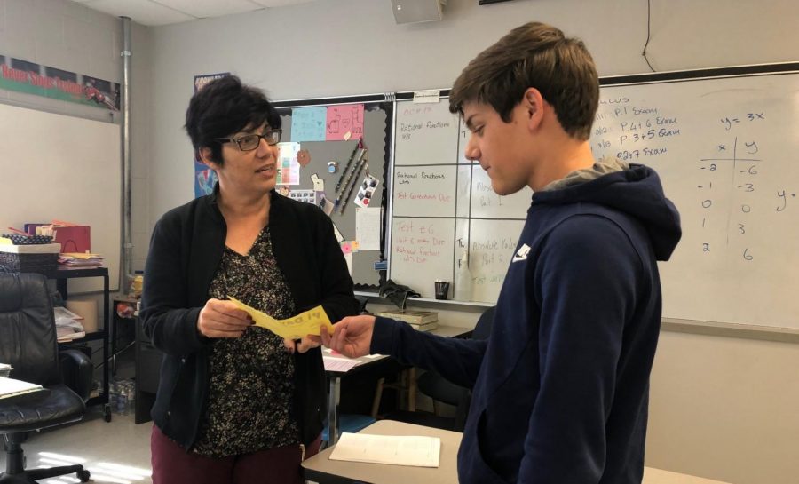 Sophomore Michael Rygh turns in his Pi Day form. Math teacher Aglaia Christodoulides, along with several other teachers, handed these slips out for students to select the pies they wished to purchase.