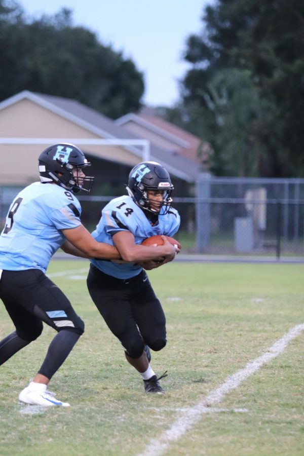  Quarterback J.J. Baird hands the ball off to running back Ethan Lopez against Gateway. The team would go on to win 23-0.  