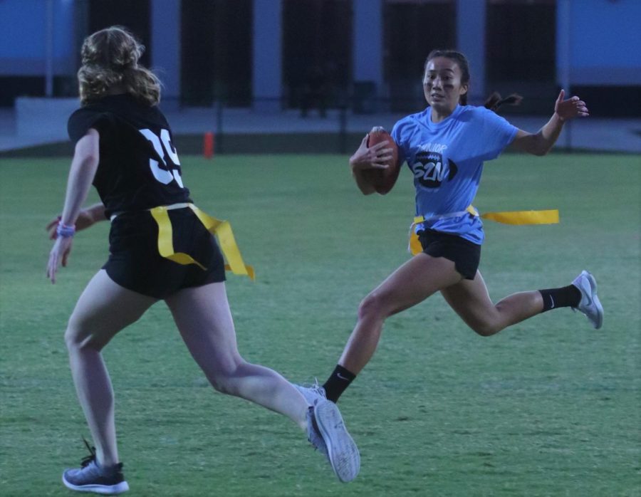 Junior Grace Truong runs the ball down the field in pursuit by a senior middle player. This play resulted in the juniors second touchdown.

