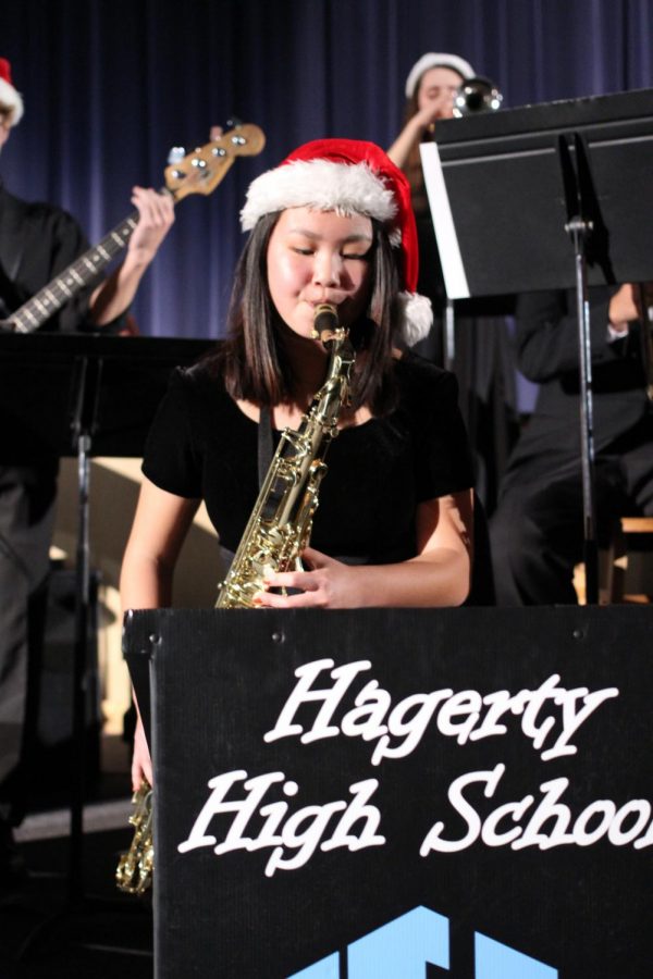 During Rhapsody in Blue, junior Olivia Schultz plays tenor sax during the opening number for the Jazz band, Little Drummer Boy. At the concert, combined bands played holiday music and individual sections arranged their own pieces for the event.