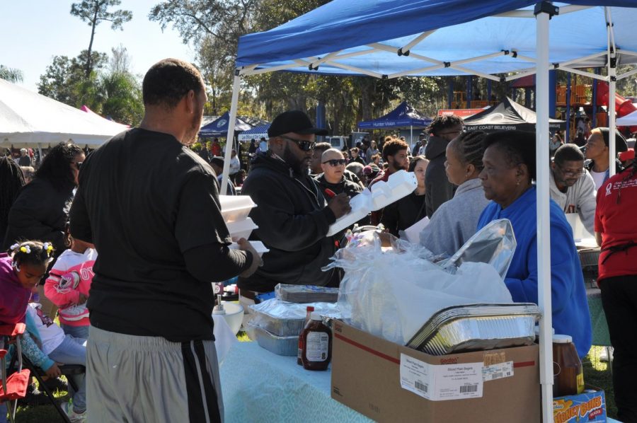 Local volunteers help serve the community barbecue.