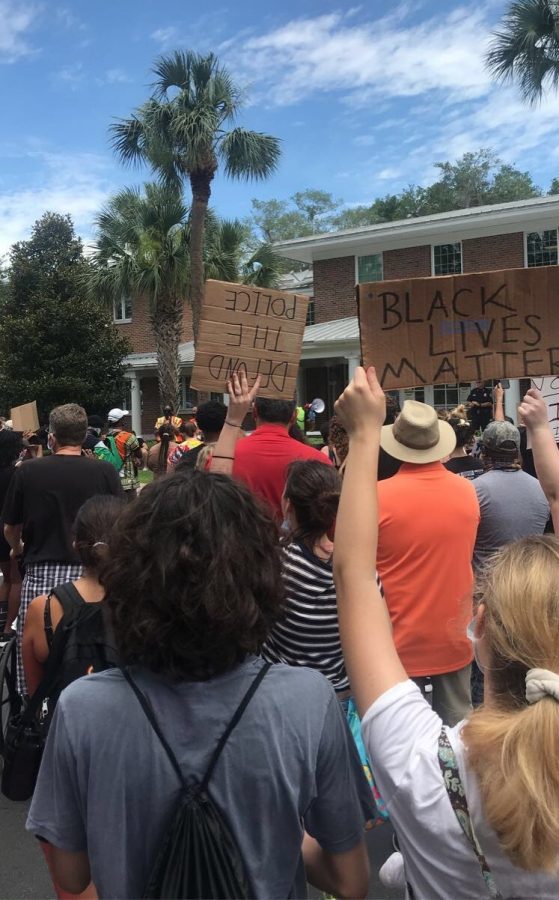 Seniors John Doe* and Sarah Rifenberg join the rest of the crowd marching down Alexandria Blvd. Students from Hagerty and Oviedo High attended.