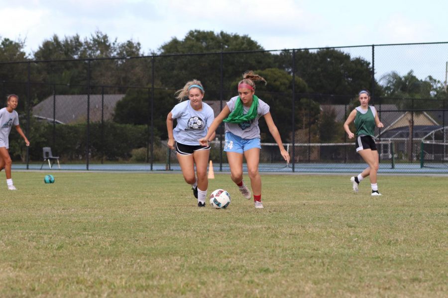 Midfielders Addison Smith and Sierra Youngblood battle for control of a ball in a drill during practice for their upcoming regular season.