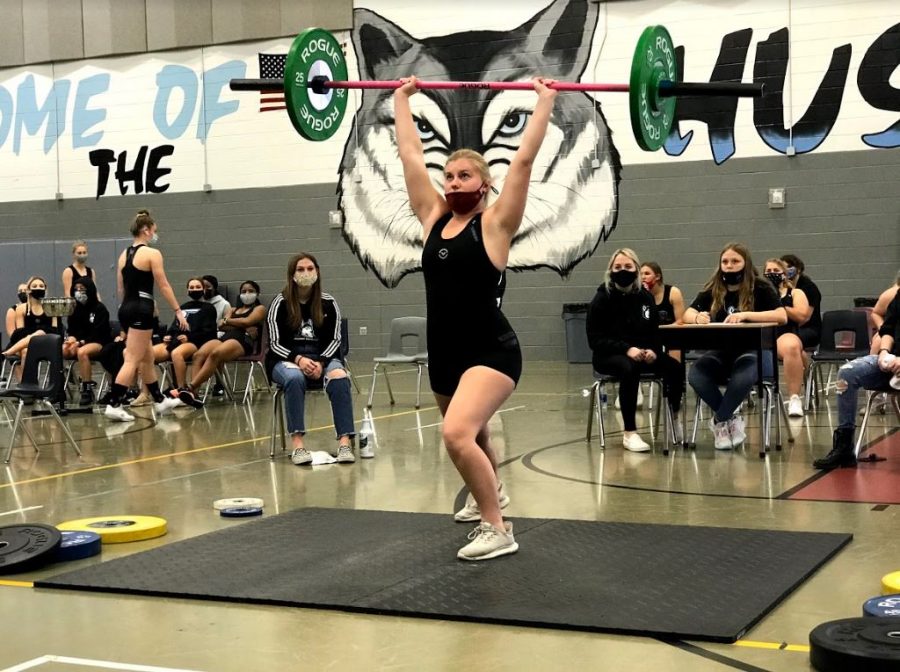 Senior Nadia Briggs performs her clean and jerk during the competition against Lake Mary.