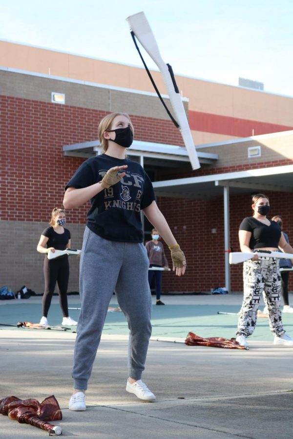 During rifle routine practice, freshman Margaret Neely works on her toss. The more difficult part of the routine included eight straight counts of spinning.
