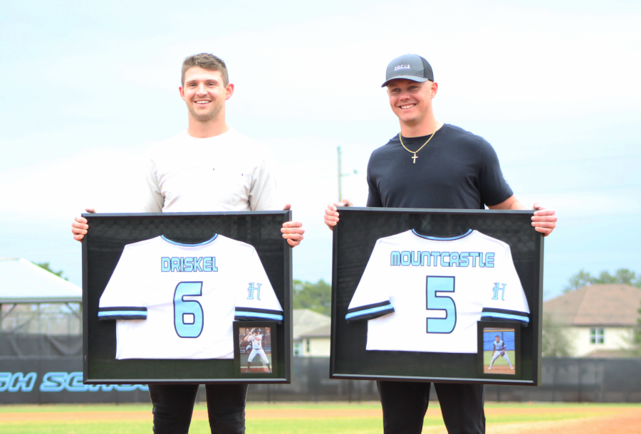 Broncos quarterback Jeff Driskel (left) and Orioles third baseman Ryan Mountcastle (right) accept their retired jerseys at home plate. 