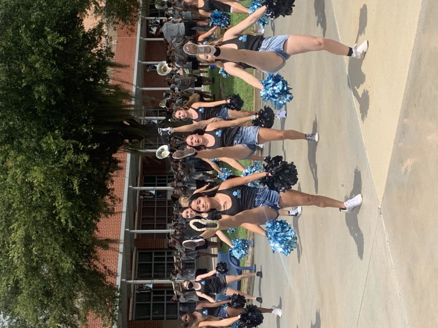 The dance team, accompanied by the varsity cheer team and marching band, preformed during both lunches last Friday to kick off the first game of the football season. Students crowded around, excited as they preformed. 
